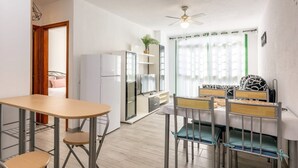 A compact living space with a kitchenette, a dining area, and a sleeping area with a bed and two chairs. - Vacation Home 'Los Abrigos Sea View' with Ocean Views, Balcony and Wi-Fi (Los Abrigos)