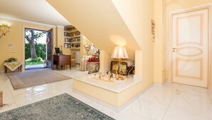 A spacious living area with a high ceiling, a large window, and a door leading to a balcony. - Villa Marchese Bed and Breakfast – Deluxe with Balcony (Trecastagni)
