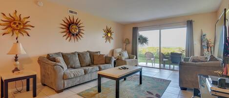 A living room with a sofa, a coffee table, and a TV stand.