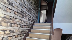 A staircase with wooden steps and a stone wall. - Eifel Pearl Manderscheid 2 (Manderscheid)