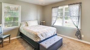 A bedroom with a bed, a desk, and a ceiling fan. - 2 Mi to Ft Sill: Home w/ Fenced Yard, Near Walmart (Lawton)