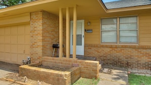 A single-story house with a garage, a front porch, and a brick foundation. - 2 Mi to Ft Sill: Home w/ Fenced Yard, Near Walmart (Lawton)