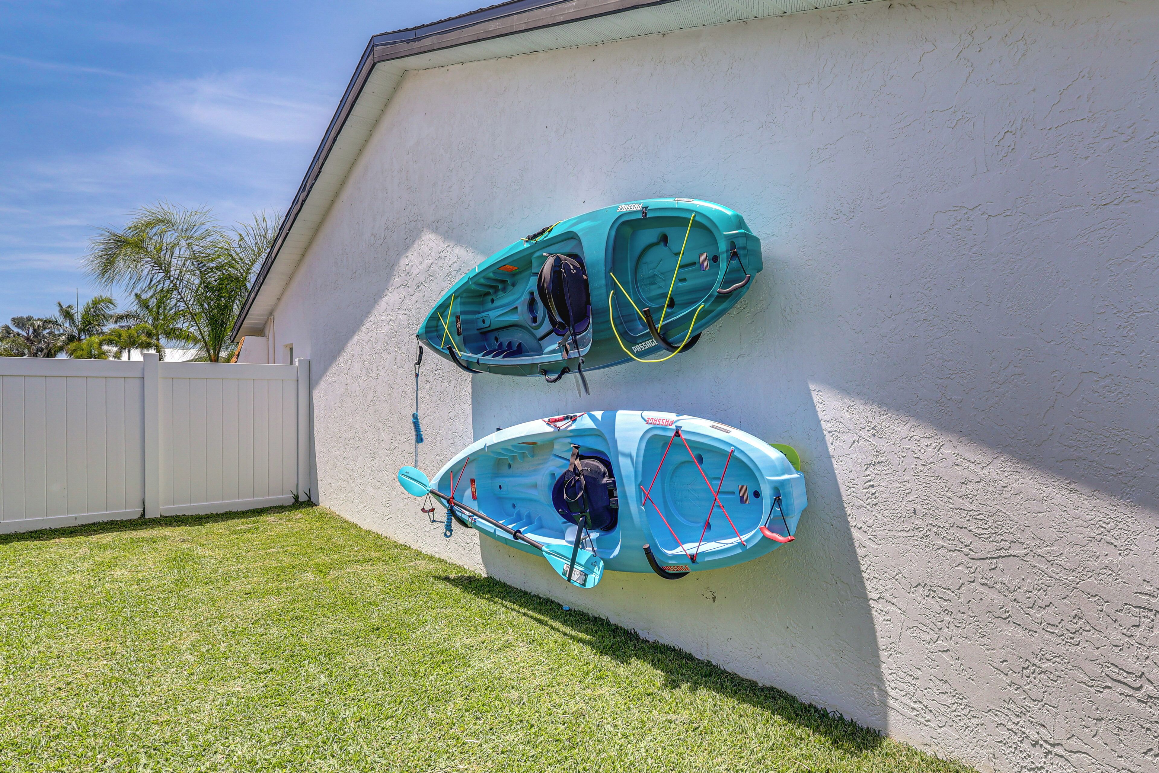 Two kayaks mounted on a wall.