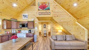 A cozy wooden interior with a kitchen, dining area, and a living room with a sofa. - Tranquil 'red Magnolia Cabin' Near Lake Granbury! (Granbury)