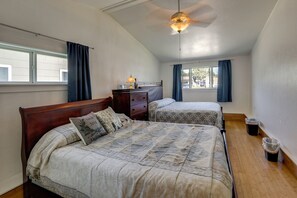 A bedroom with two beds, a ceiling fan, and a window with curtains. - 1950s Home Quiet Street Near Dtwn 1 Mi to Marina (Sparks)