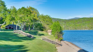 A lakeside property with a wooden bridge, a small building, and a large tree. - Easy Schroon Lake Living! Close to Marina & Town (Schroon Lake)