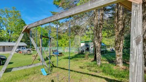 A wooden swing set in a grassy yard with a small building and picnic table in the background. - Close to Marina, Beach & Town! Schroon Lake Escape (Schroon Lake)