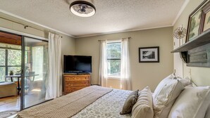 A bedroom with a bed, a television, a dresser, and a window with curtains. - Private Family Home w/ Ocoee River Access (Benton)
