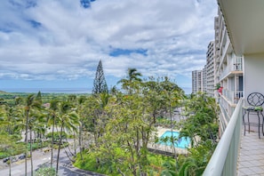 A hotel with a pool, lush greenery, and a view of the ocean. - Pool Access, 1 Mi to Makaha Beach! Ocean-view Unit (Waianae)