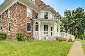 A two-story house with a prominent bay window, a front porch with a white railing, and a small front yard with a pathway. - Historic Home 3 Mi to Middletown Main Street (Middletown)