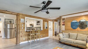 A modern interior with a kitchen, dining area, and living room.