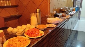 A buffet counter with various food items and condiments. - The Pride Gitbitan (Asansol)