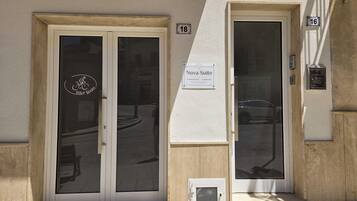 A building entrance with two doors, one labeled 'Bike Room' and the other 'Nova Suite.'
