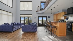 A spacious living area with a sofa set, a kitchen with wooden cabinets, and a view of the outdoors. - Rochester Lakeview 4br With Firepit Sleeps 6 4 Bedroom Home (Rochester)