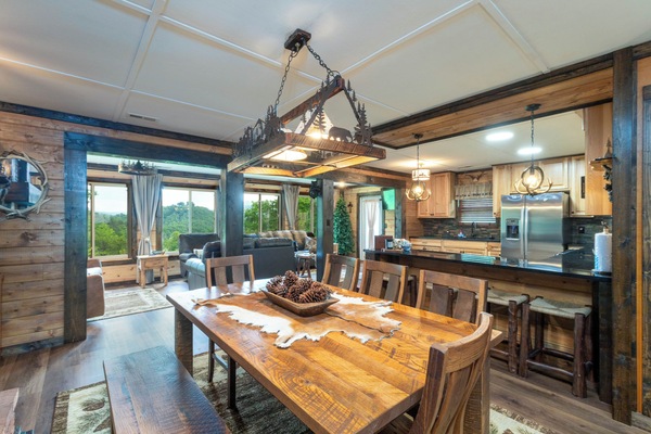Dining Room – Rustic Table with Mountain Chandelier - Dining area with a large rustic wood table, and a stunning mountain-themed chandelier.