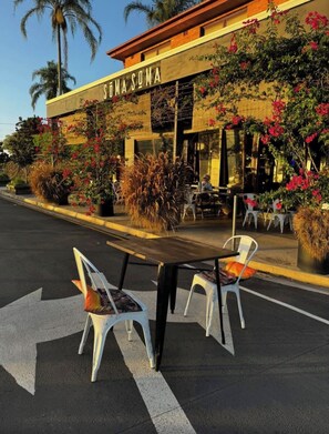 A restaurant named 'SOMA SONA' with outdoor seating and a clear view of the street.