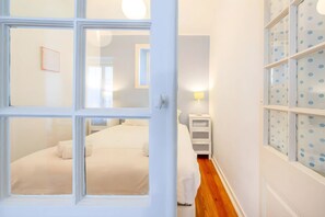 A bedroom with a bed, a nightstand, and a lamp. - Historic & Typical 1 By Gt House (Lisbon)