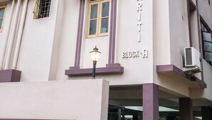 A multi-story building with a sign reading 'YOKH KRI TI BLOCK-A'. - Hotel Imperial Garden (Patna)