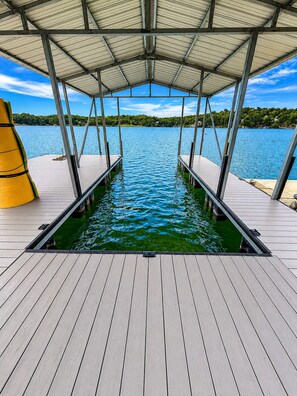 A covered dock with a swimming pool, wooden deck, and a view of a lake. - Lakefront Paradise in Double Springs, AL 6BR Cabin with Private Dock (Double Springs)