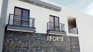 A modern building with a stone facade and balconies. - Luxury apartment #4 steps away from IMSS / UMAE (Ciudad Obregón)