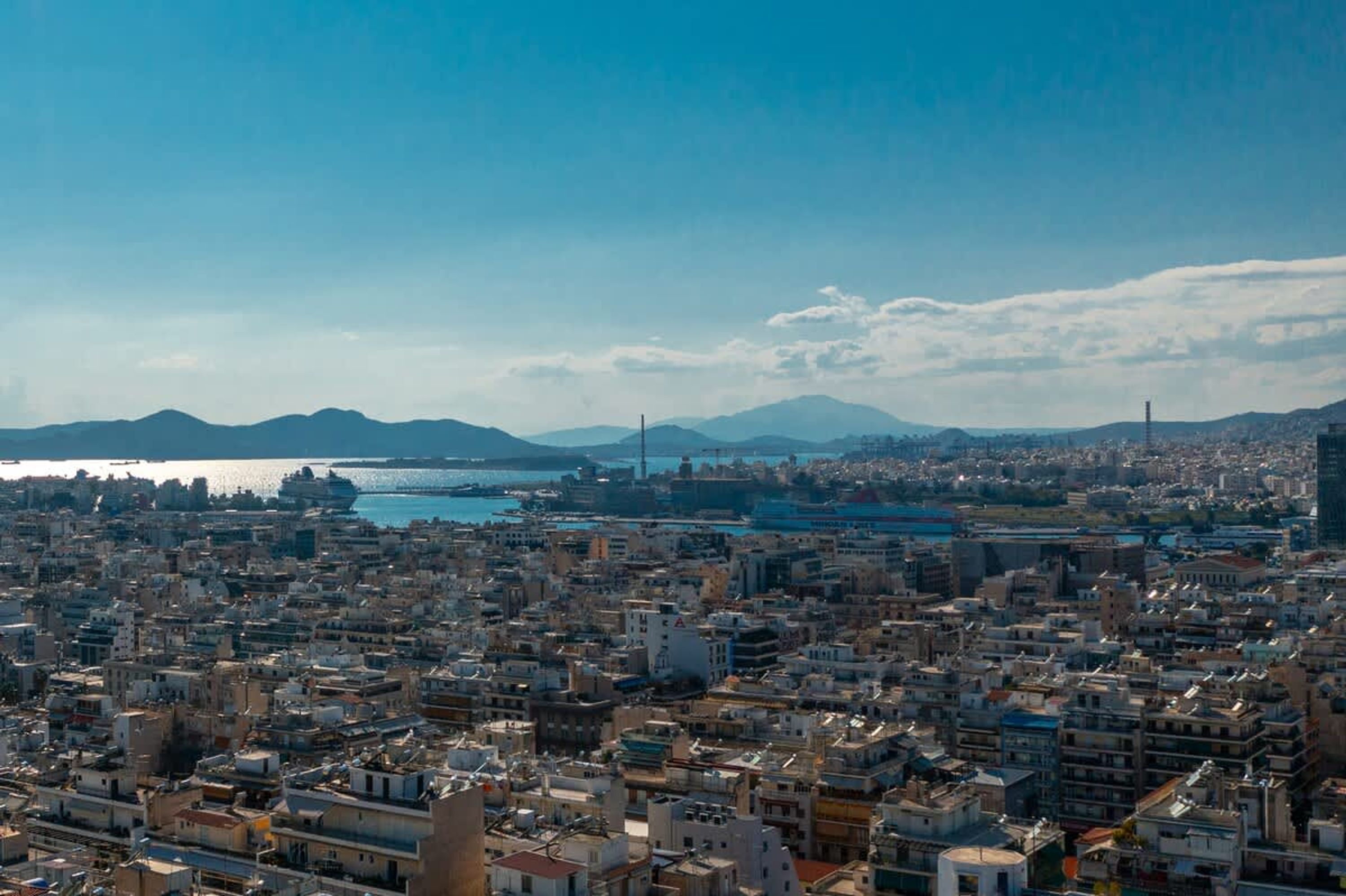 A densely packed urban area with a large body of water in the background, likely a port or harbor.