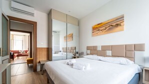 A hotel room with a bed, a mirror, a painting, and a view of the outdoors. - GuestHost - Modern Flat X4 near the Center (Trieste)