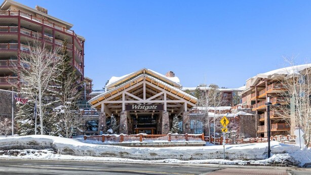 A Westgate building with a covered entrance, stone pillars, and a snow-covered ground. - 2 bdrm Ski in/Ski out Westgate Resort in Beautiful Park City (Park City)