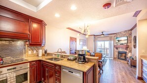 A kitchen with a dishwasher, stove, and a coffee maker. - 2 bdrm Ski in/Ski out Westgate Resort in Beautiful Park City (Park City)
