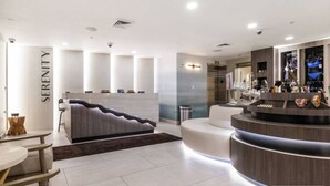 A modern hotel lobby with a reception desk, seating area, and a staircase leading to an upper floor. - 2 bdrm Ski in/Ski out Westgate Resort in Beautiful Park City (Park City)