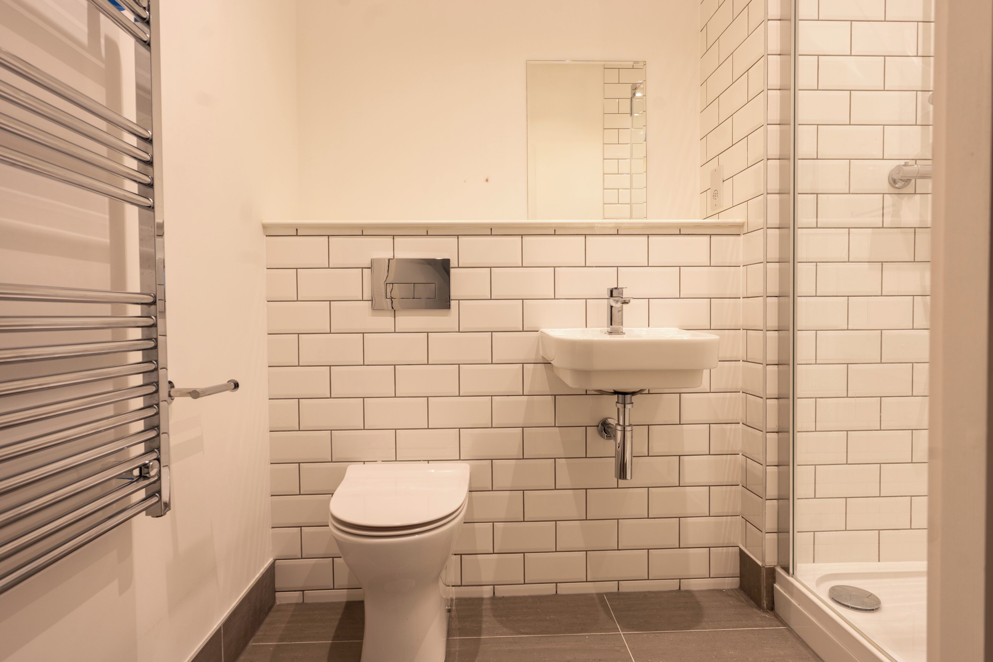 A bathroom with a toilet, sink, and shower.