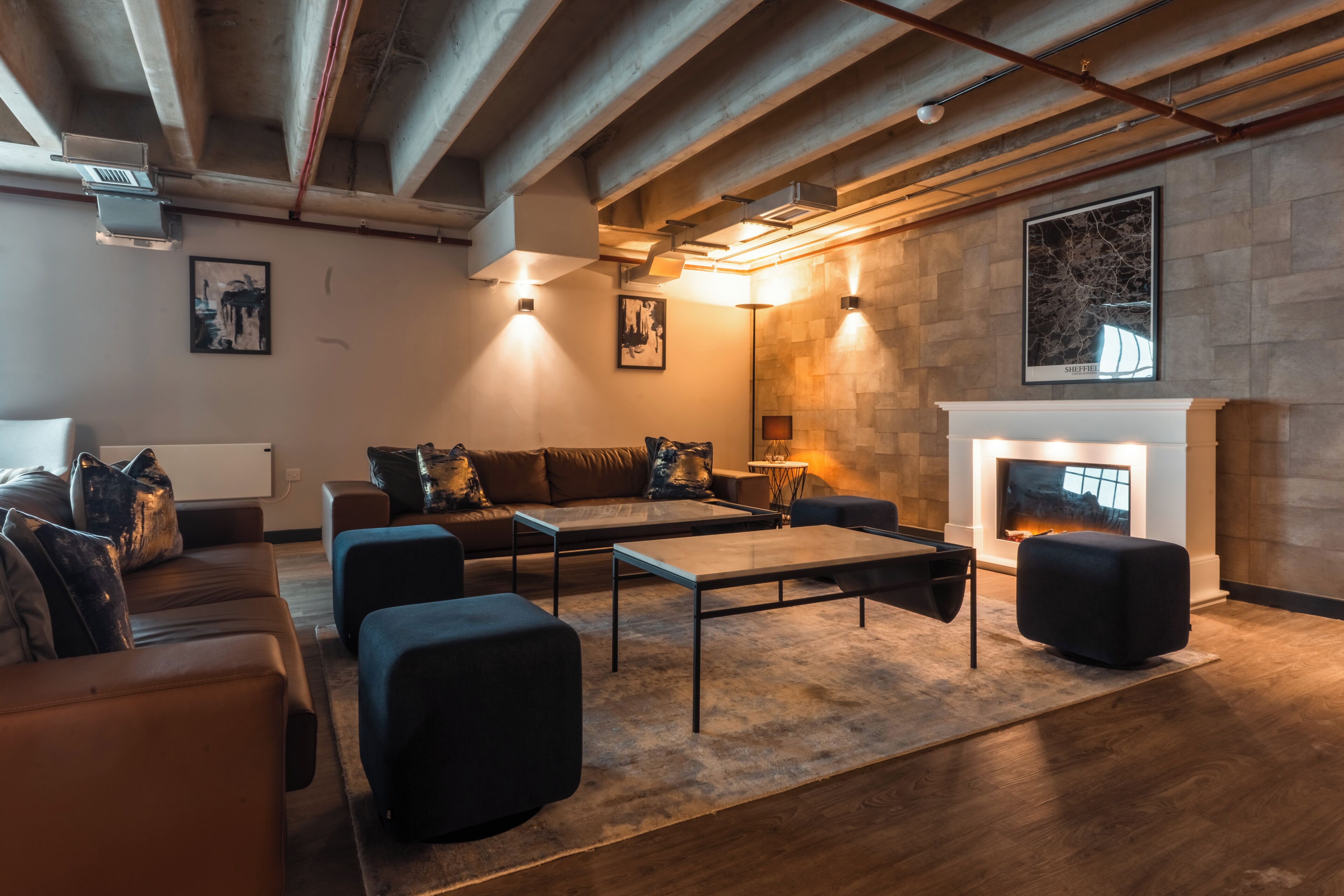 A modern living room with a fireplace, sofas, and a coffee table.