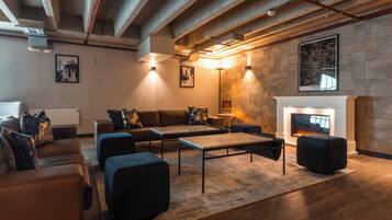A modern living room with a fireplace, sofas, and a coffee table.