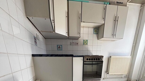 A kitchen with white cabinets, a stove, and a trash bin. - Stylisg retreat with private entrance, minutes from blue water.Free parking (Stone)