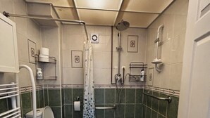 A small, compact bathroom with a toilet, shower, and a waste bin. - Stylisg retreat with private entrance, minutes from blue water.Free parking (Stone)