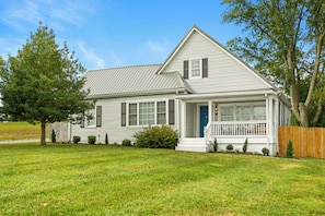 A single-story house with a front porch, a covered entryway, and a small front yard.