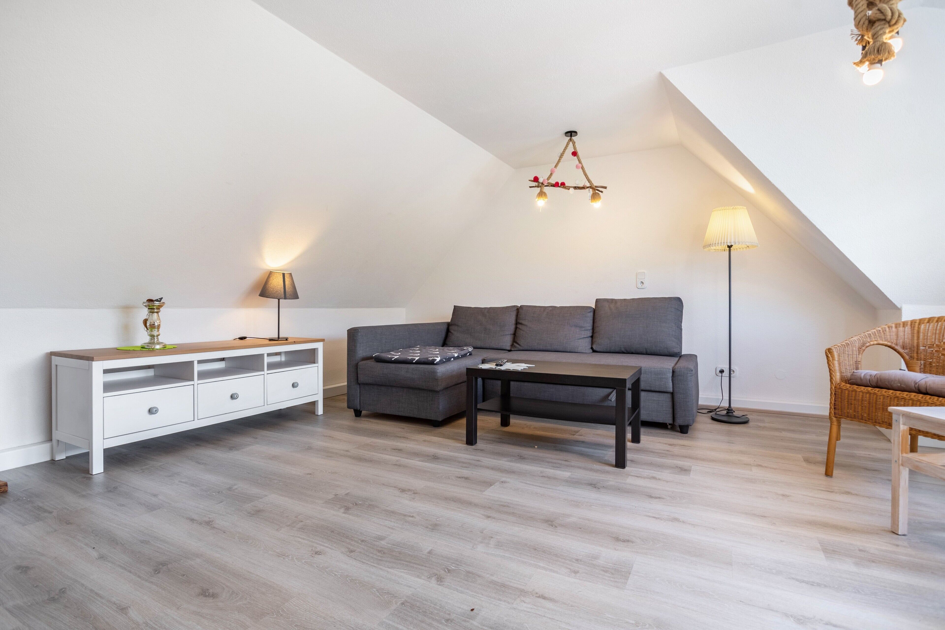 A modern living room with a sofa, coffee table, and a white console table.