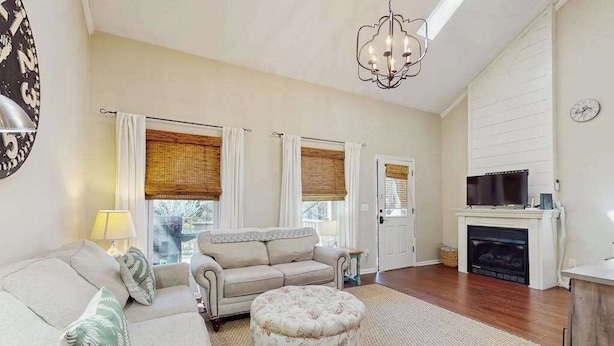 A living room with a sofa, ottoman, and fireplace. - Ripple Run (Sylva)