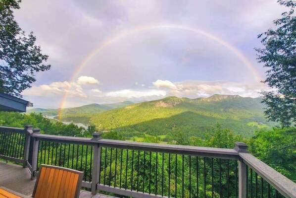 A deck with a view of a mountain range and a rainbow. - Mountain gem w/pool,golf, hot tub, tennis, beach, wellness center - dog-friendly (Lake Lure)