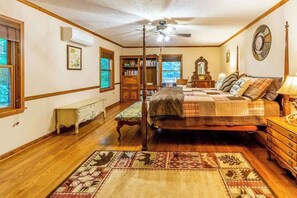 A bedroom with a bed, a ceiling fan, a bookshelf, a dresser, and a window. - Lazy Bear Lookout (Franklin)
