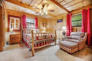 A cabin interior with a wooden bed, a chair, a nightstand, and a sign reading 'Welcome Cabin.' - Black Bear cabin fox Mountain (Franklin)