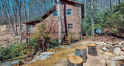 Mountain home nestled in the forest with a stream, deck, firepit, & game room
