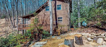 Mountain home nestled in the forest with a stream, deck, firepit, & game room