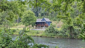 A house by a river surrounded by greenery. - at E's please (Cullowhee)