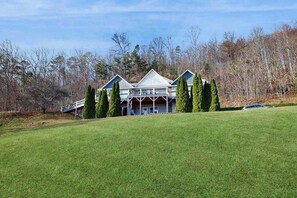 A large, multi-story building with a symmetrical roofline and a covered porch area. - The Overlook Upper Retreat (Franklin)