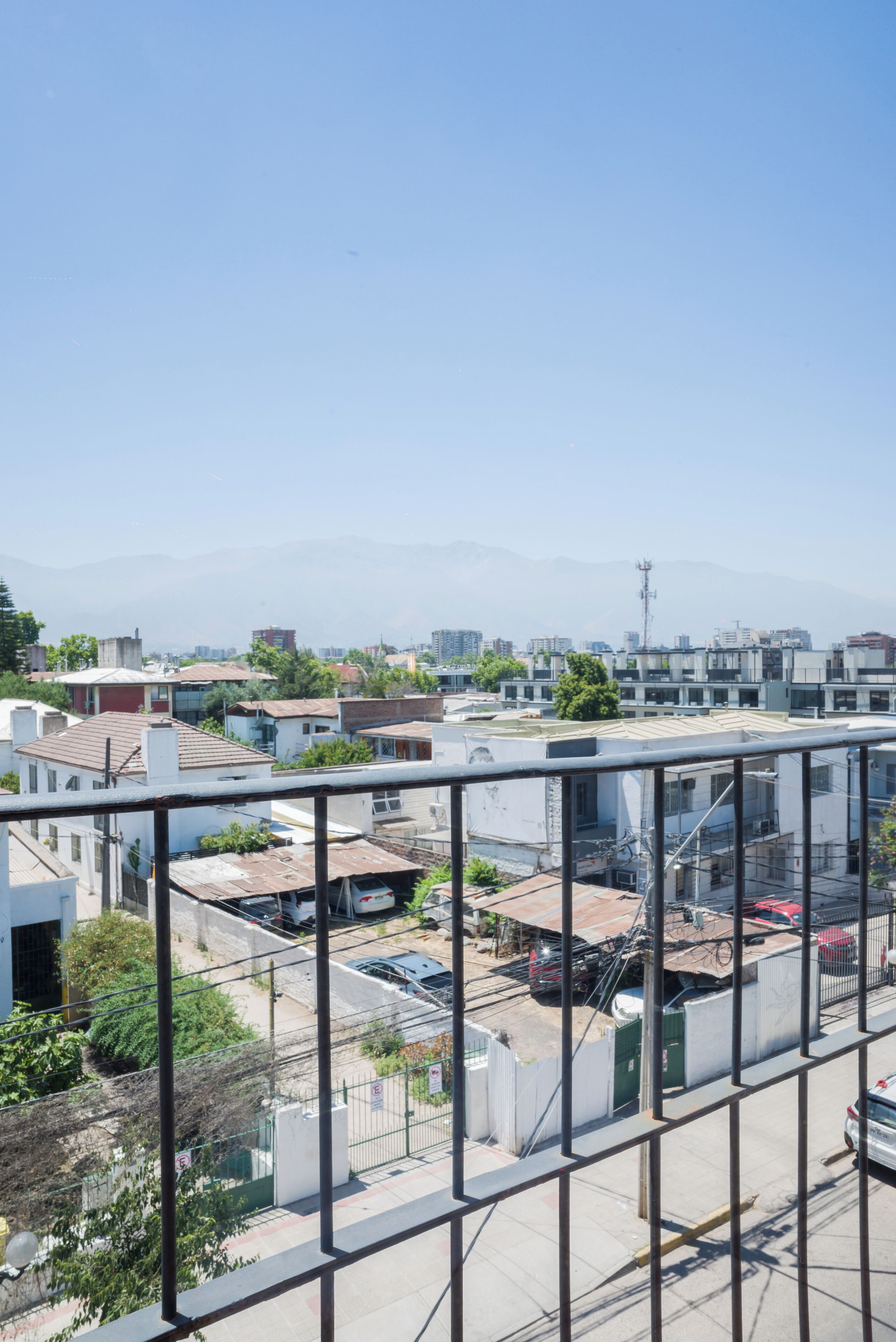 A residential area with buildings, a street, and a clear sky.