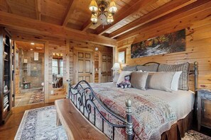 A wooden cabin interior with a bed, bench, and a painting on the wall. - Bear Hug (Sylva)