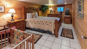 Un dormitorio de estilo cabaña con cama, cómoda, mesita de noche y cuna.
