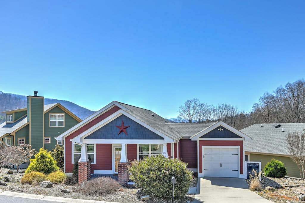 A residential building with a garage, a red star on the front, and a clear blue sky.