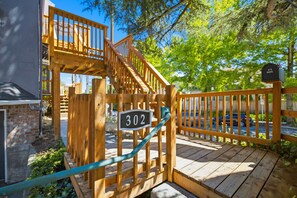A wooden staircase leading to a deck with a mailbox labeled '302'. - Historic Cap Hill Oasis w/View | Dogs Stay Free! (Seattle)
