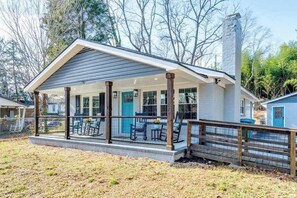 A single-story house with a covered porch, a chimney, and a fenced yard. - Contemporary dog-friendly mountain home with firepit, grill, enclosed backyard (Swannanoa)